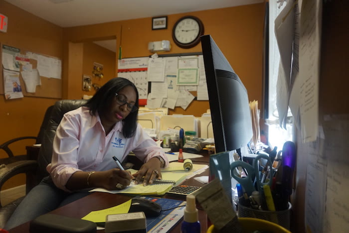 Claudette, operations manager, at her desk
